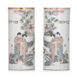 A pair of Chinese famille rose cylindrical vases, with signed texts, Republic period, H 28 cm