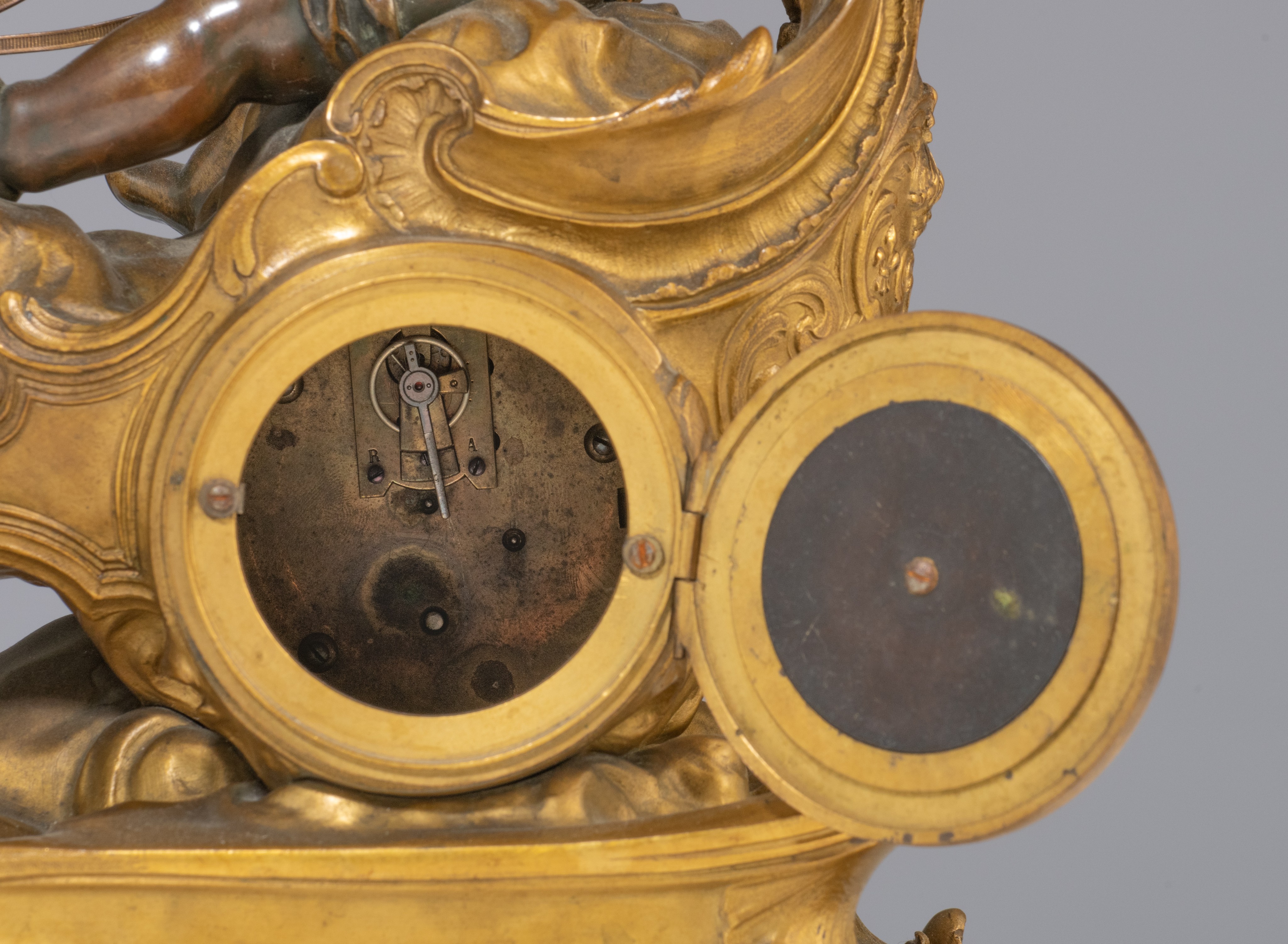 A Rococo style mantle clock with Cupid on his chariot and a pair of matching candlesticks, H 19,5 - - Image 8 of 9