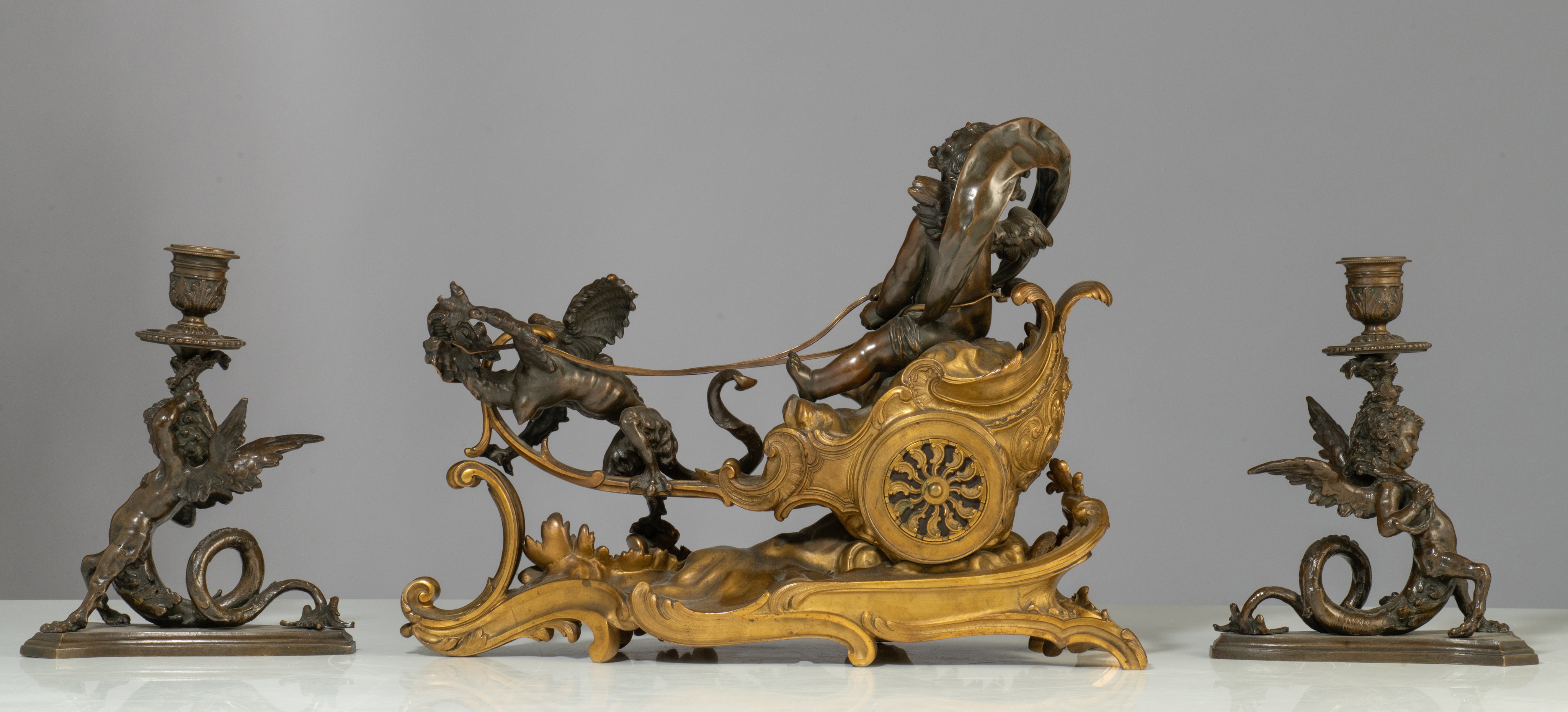 A Rococo style mantle clock with Cupid on his chariot and a pair of matching candlesticks, H 19,5 - - Image 3 of 9