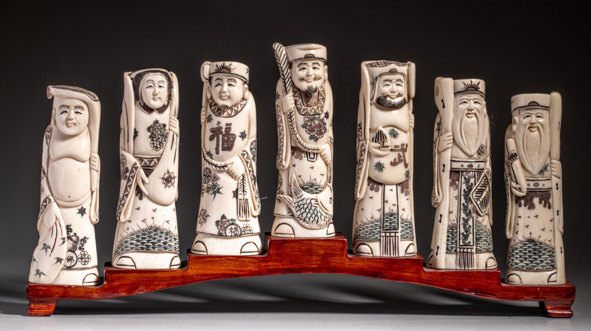 A collection of Japanese carved bone figures, depicting the Seven Immortals, H cm