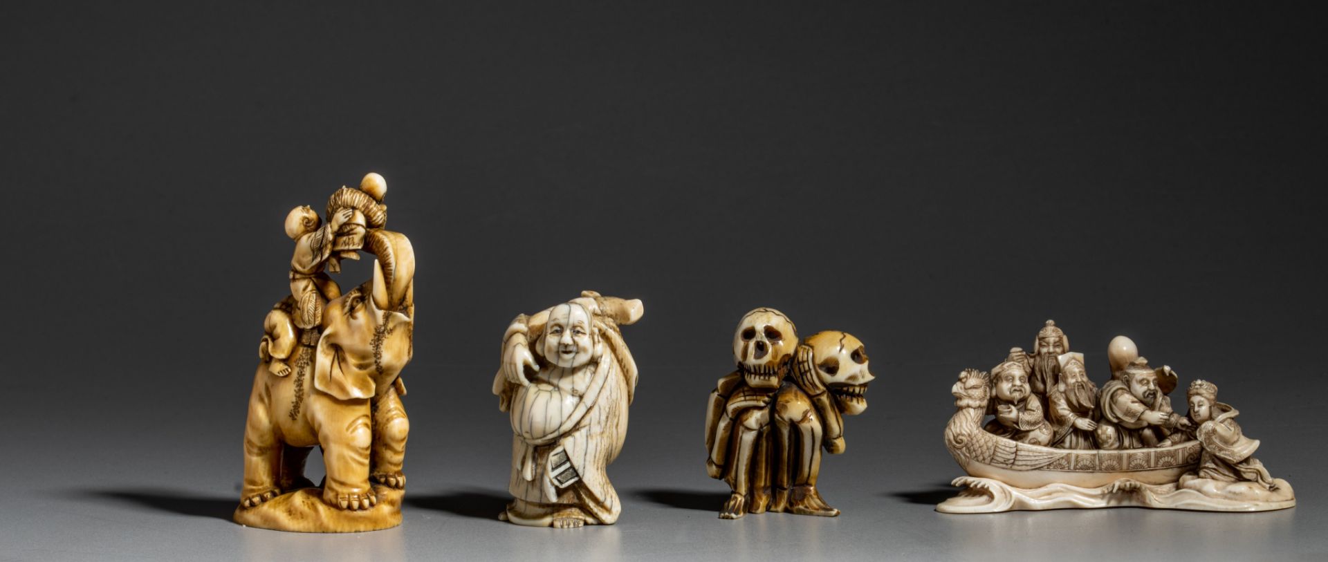 A collection of three Japanese carved okimono and one netsuke (+)