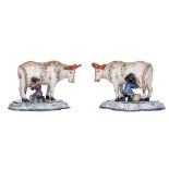 A pair of Amsterdam polychrome models of cows with milkers, marked GDG, 18thC, H 14 - 14,5 cm