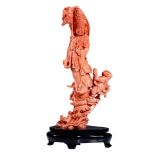 A Chinese finely carved coral figure of standing Guanyin, late Qing, H 22 cm (coral only) - Total H