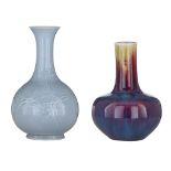A Chinese flambe-glazed bottle vase, H 30 cm - and a Chinese pale blue ground relief decorated bottl