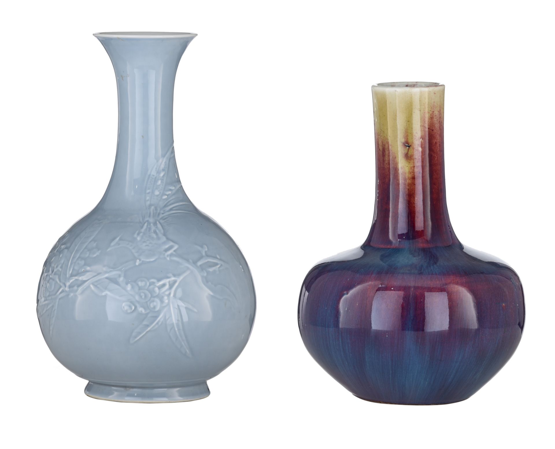 A Chinese flambe-glazed bottle vase, H 30 cm - and a Chinese pale blue ground relief decorated bottl