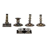 A collection of Limoges painted enamel objects: 4 candlesticks and a salt cellar, H 3 - 16 cm