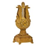 A gilt bronze lyre-shaped Restauration mantle clock, decorated with swans and dolphins, ca. 1815-183