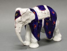 Porzellanfigur, "Elefant", Blaumarke D, 20. Jh., polychrom und goldstaffiert, 19 cm hoch