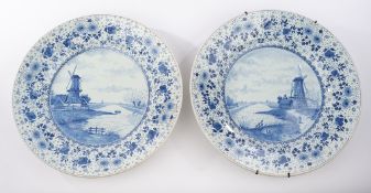 2 Fayenceplatten, wohl Delft, 19./20. Jh., Blaudekore, Landschaften mit Windmühle, florale Fahne, B