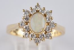 Ring, GG 750, 16 Brillanten zus. ca. 0.50 ct., 1 ovaler Vollopal (beschädigt), 4.3 g, RM 14.5