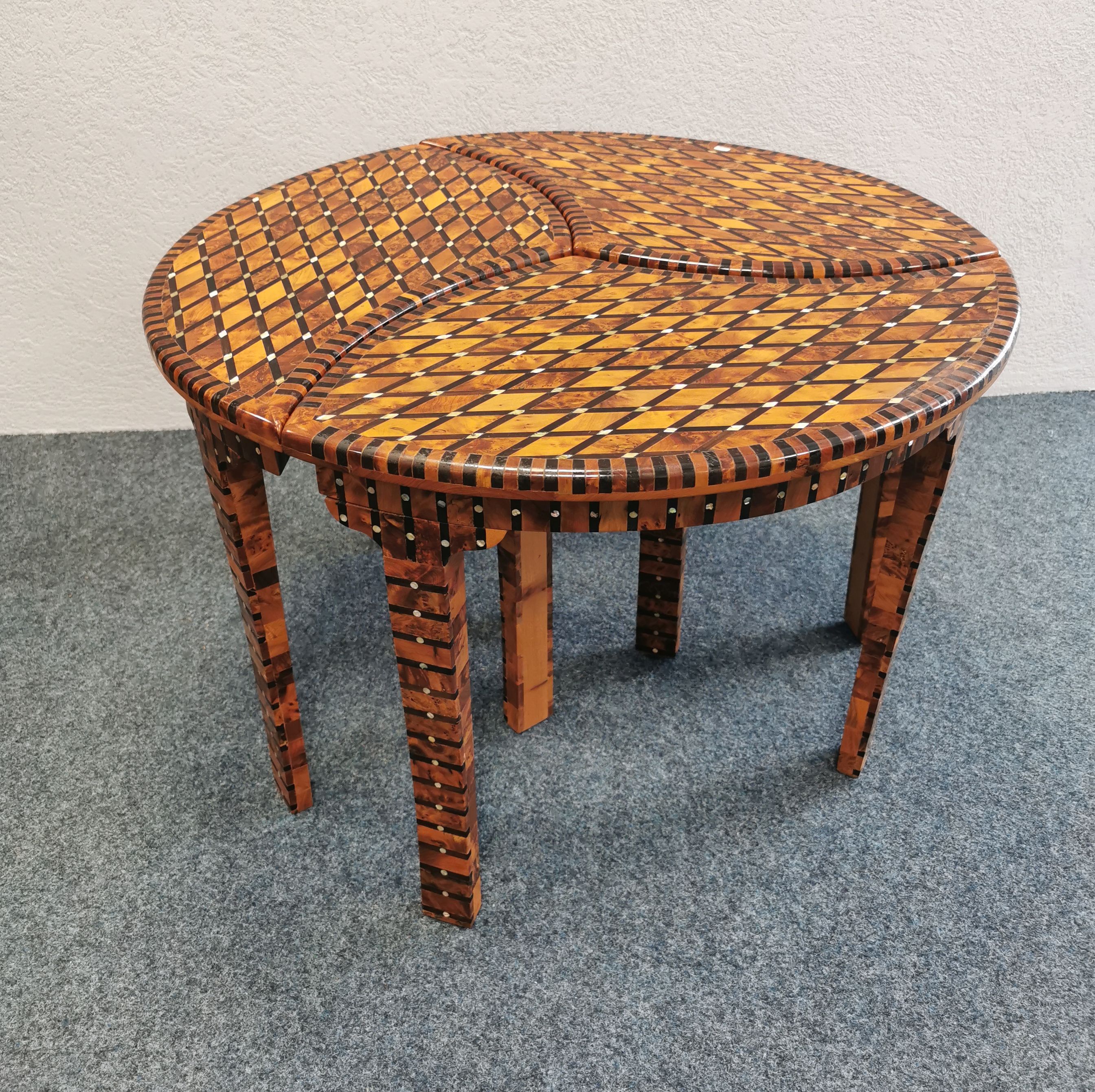 A THREE-PART CIRCULAR COUCH TABLE