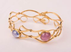 Elaborate bracelet with two precious stones, 750 yellow gold.