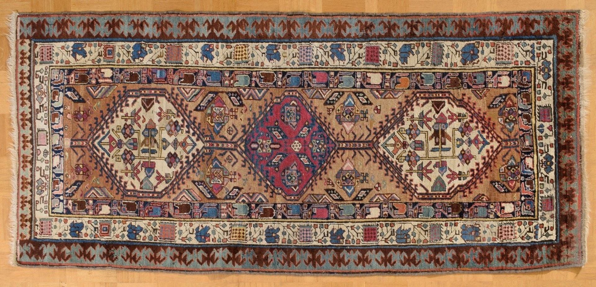 Serab carpet with a triple hexagonal-medallion and depictions of animals as well as a floral border