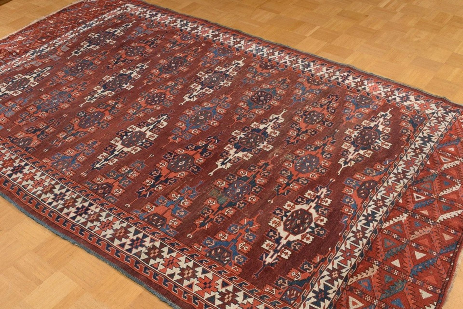 A Yomud main carpet with flat kepse güls arranged in offset colours, a white-ground main border wit - Image 2 of 7