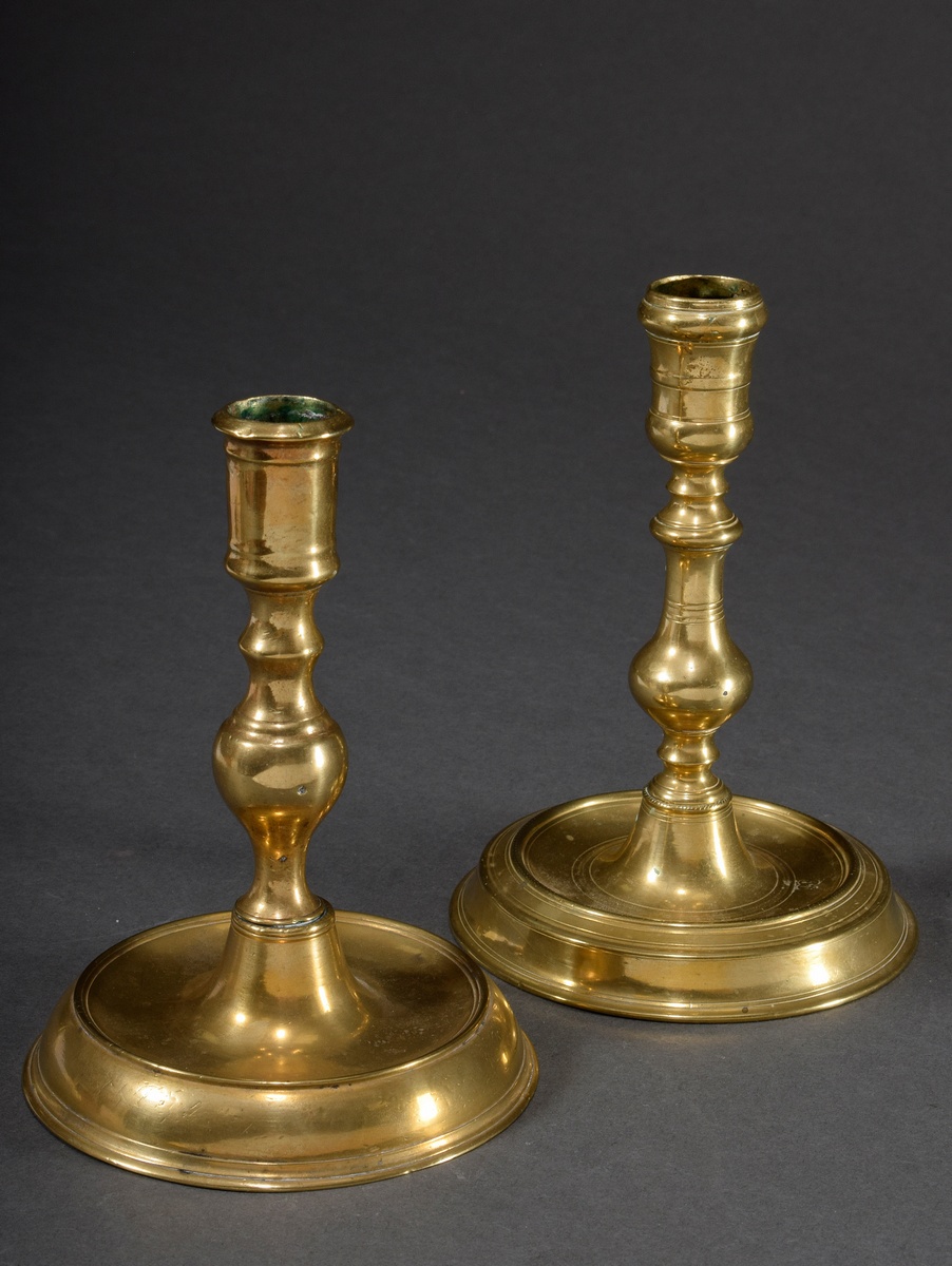 Pair of small brass candlesticks on round base with baluster shaft, 18th century, h. 16cm, small pr