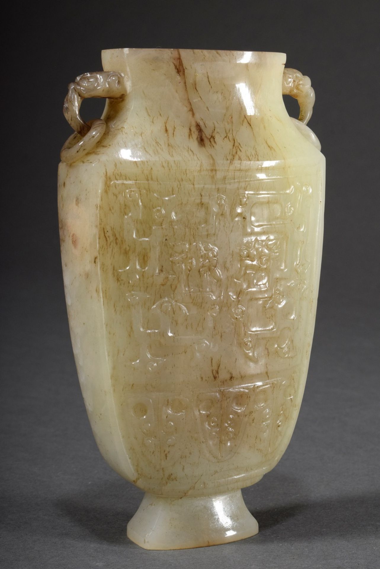 Small jade vase with archaic relief carving "dragon" on an angular body and zoomorphic ring handles