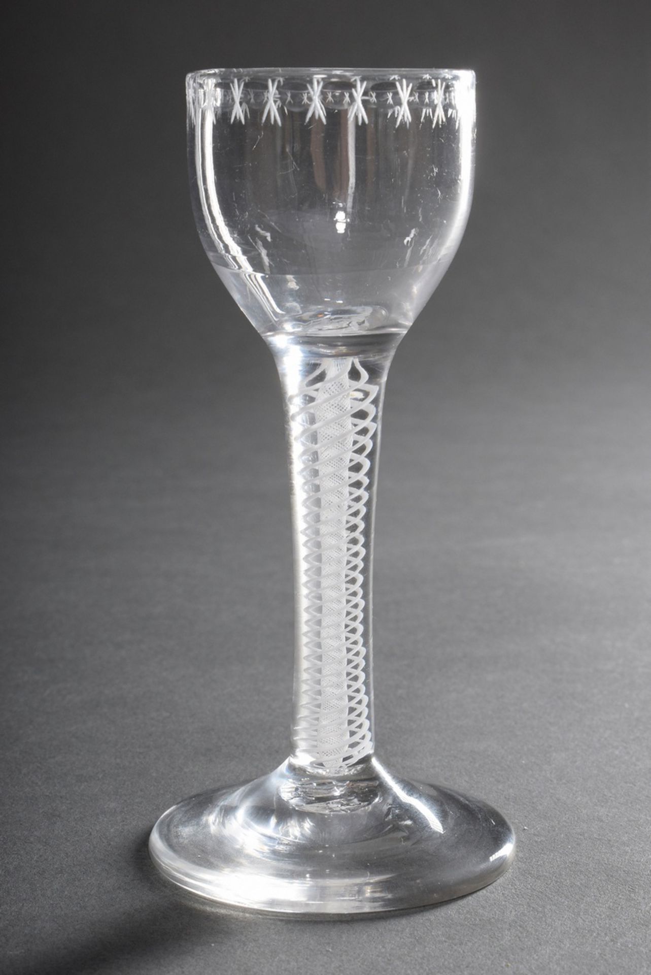Small snaps glass with white twisted threads in the stem and delicate cut leaf border on the dome, 