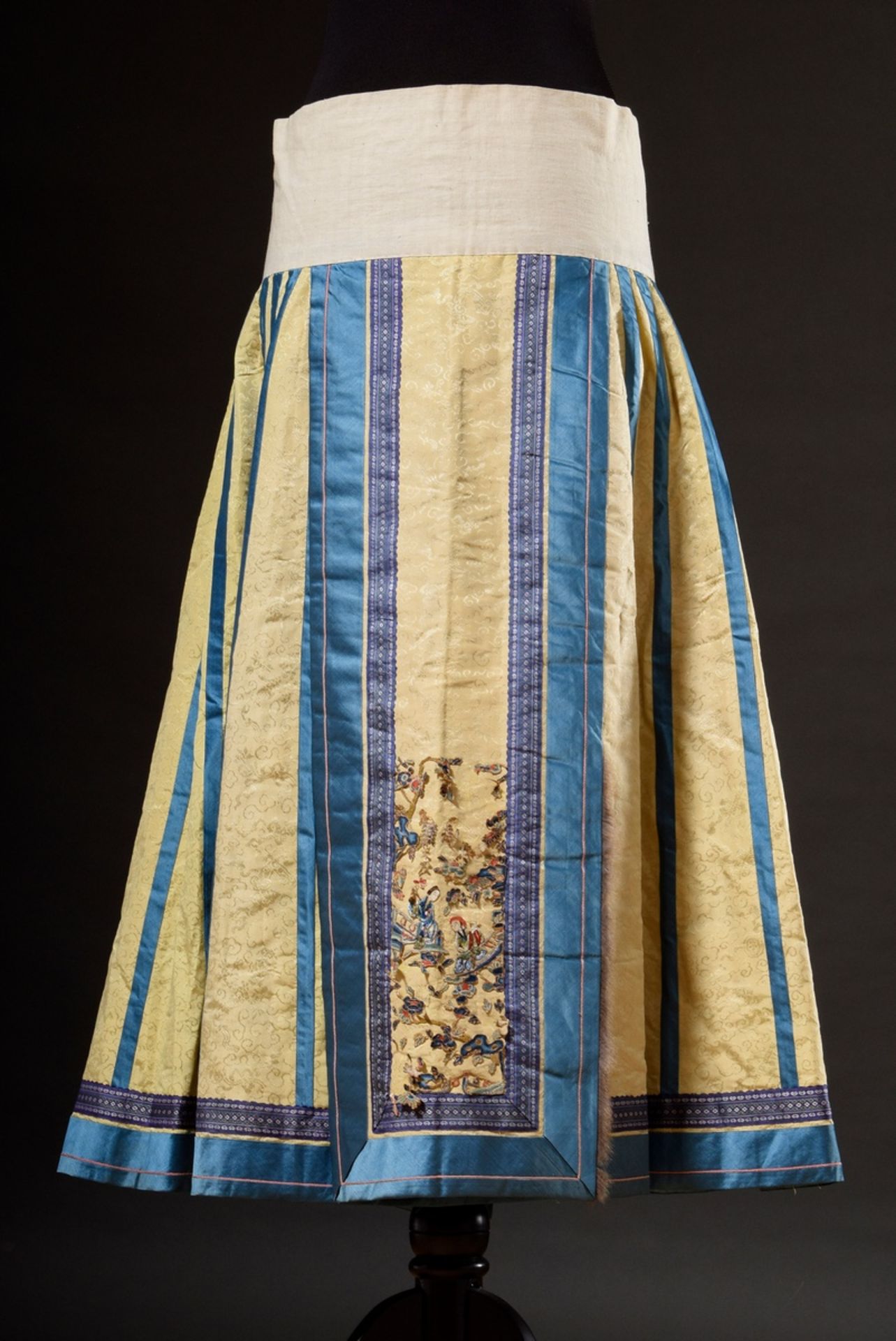 Chinese skirt of light yellow silk damask with blue borders, fairy fur trimming and coloured embroi