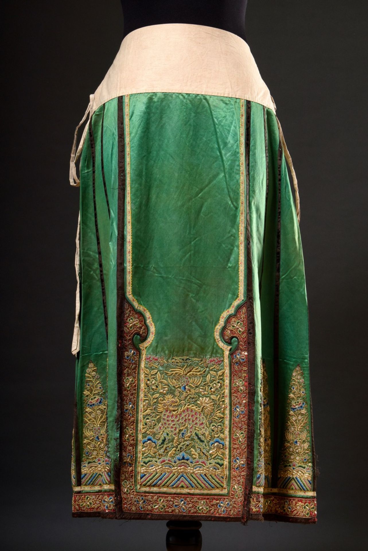 A Chinese woman's skirt in green silk with elaborate gold thread and bead embroidery as well as met