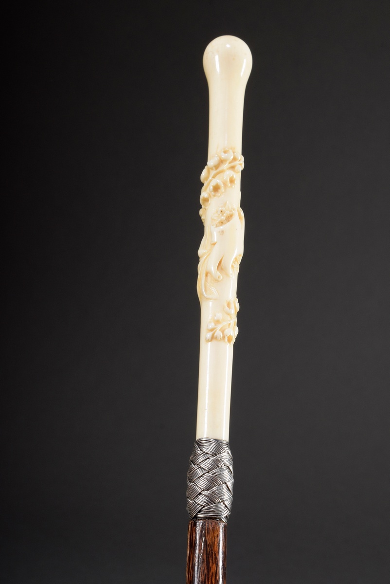 Elegant ladies' walking stick with long ivory handle merging into an oval pommel, carved all around