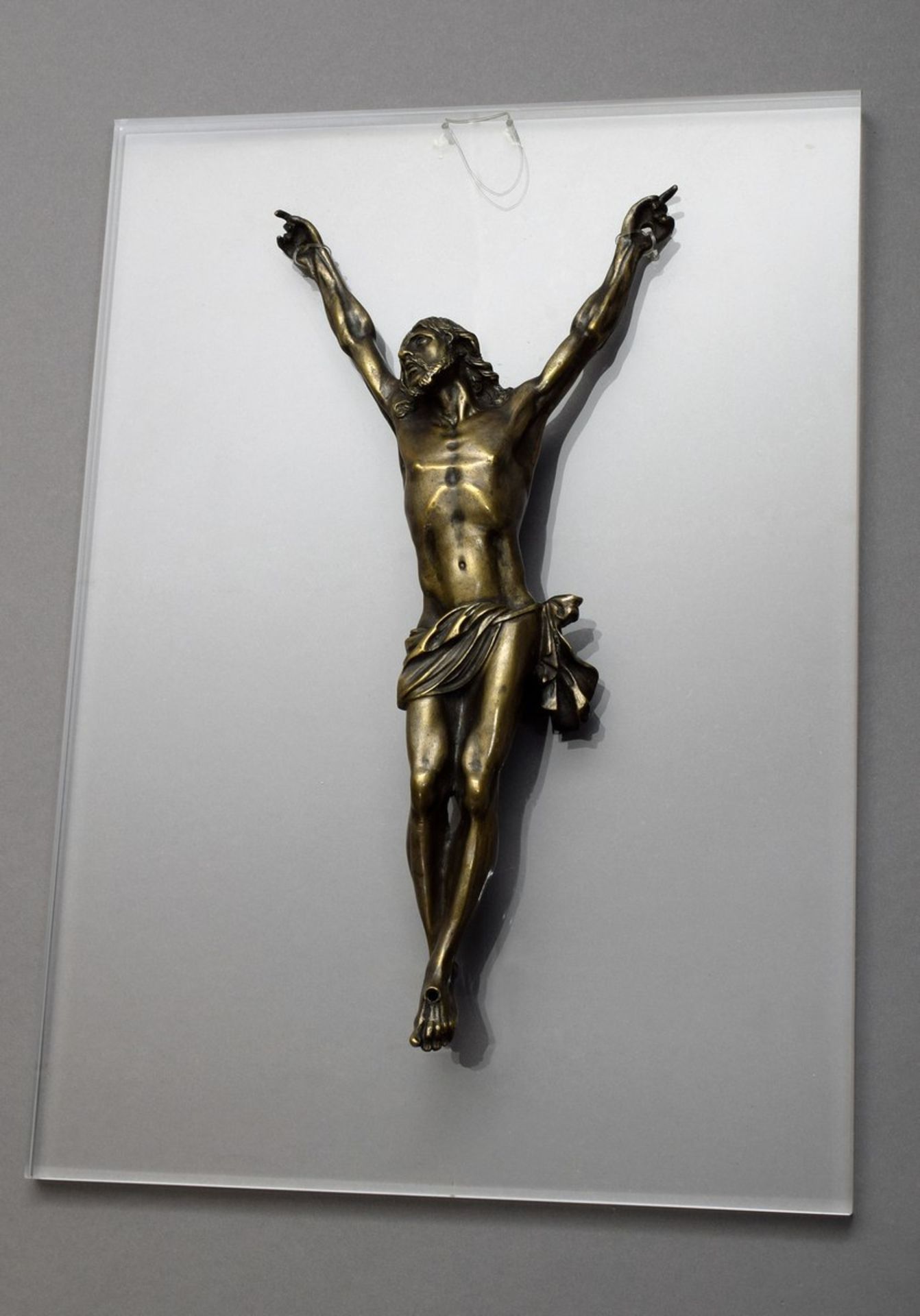 "Corpus Christi" (three-nail type) with arms stretched far upwards and head raised, bronze with rem