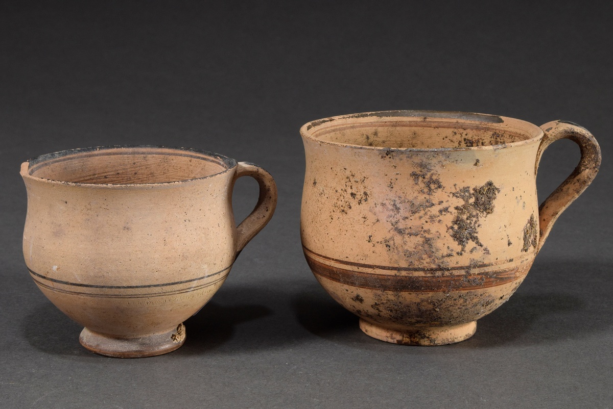 2 Various Hellenistic handle cups, reddish clay with black painting, partly with earth adhesion, 4t