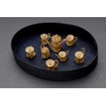 Miniature tea set made of shark vertebrae bones, mounted in chip box, 3x11x7,5cm (with box), slight