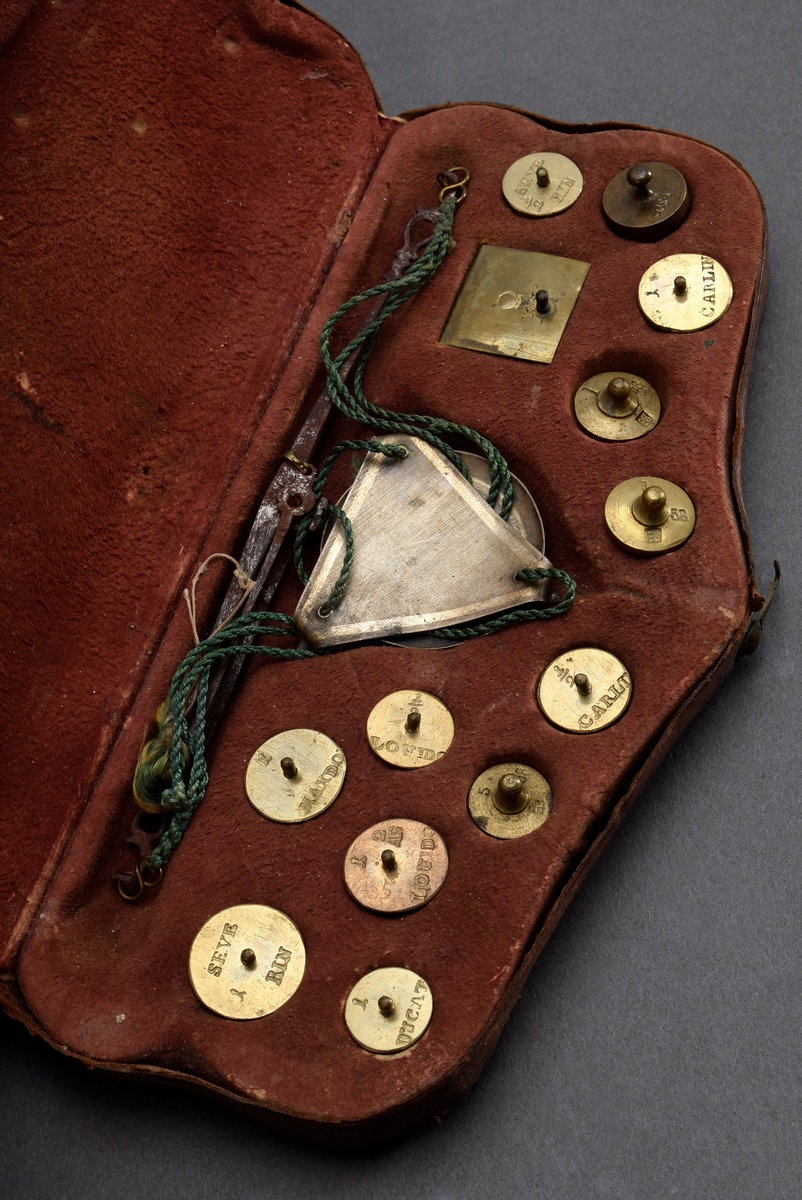 Coin balance with twelve weights in richly punched leather case, probably 18th century France, 2.5x