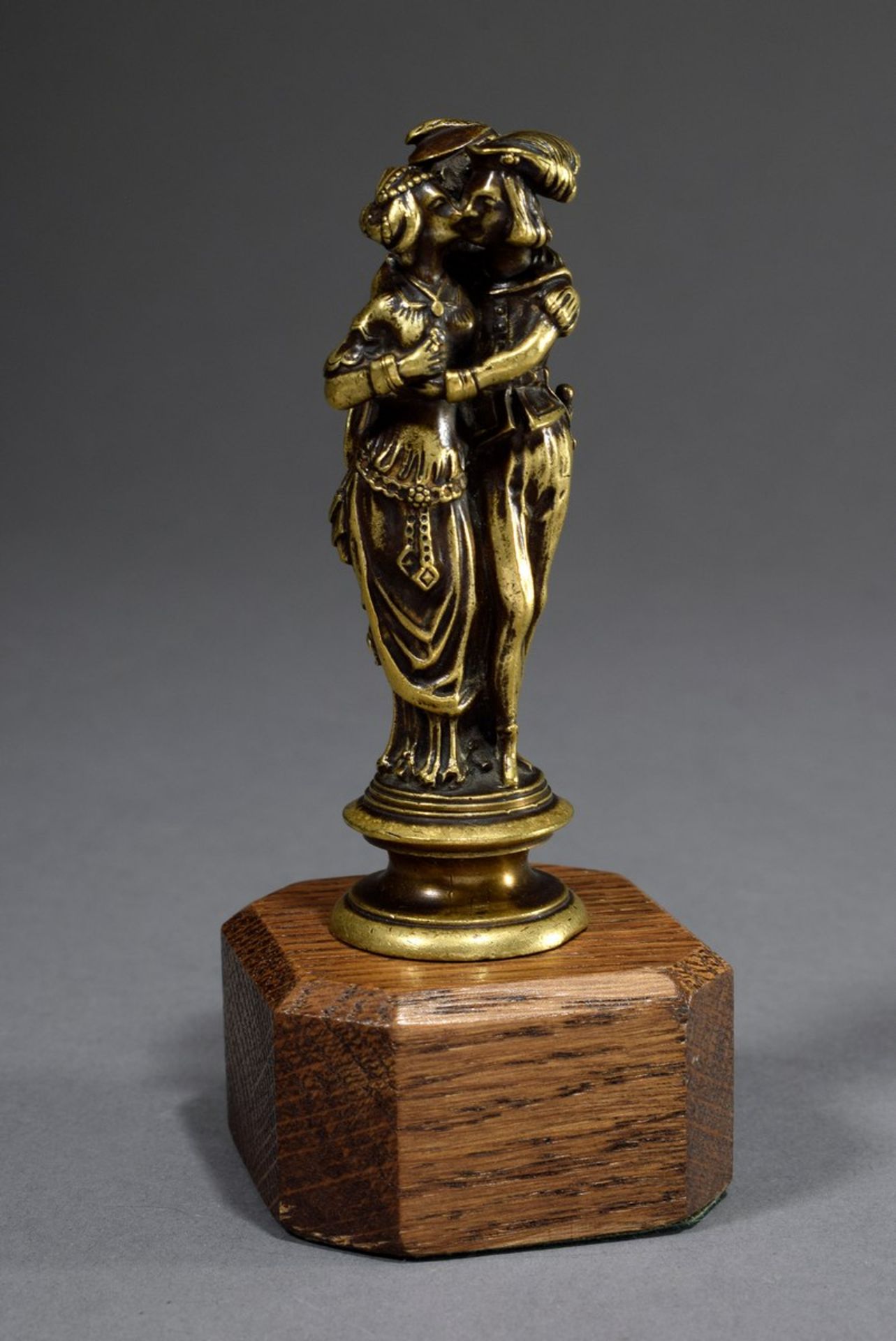 Petschaft with figural handle "Allegory of Love and Jealousy" in medieval façon, brass on wooden ba