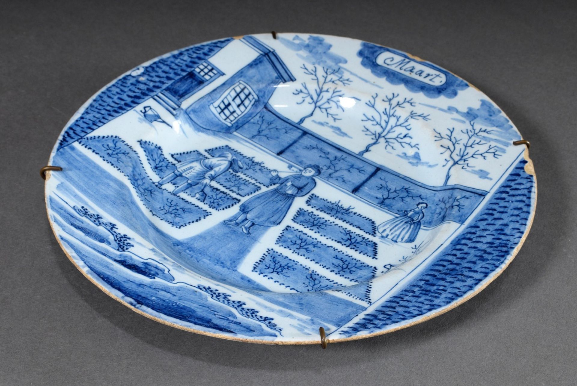 Delft faience plate "Maart" from monthly series with blue painting decor "Scene in the garden", De 