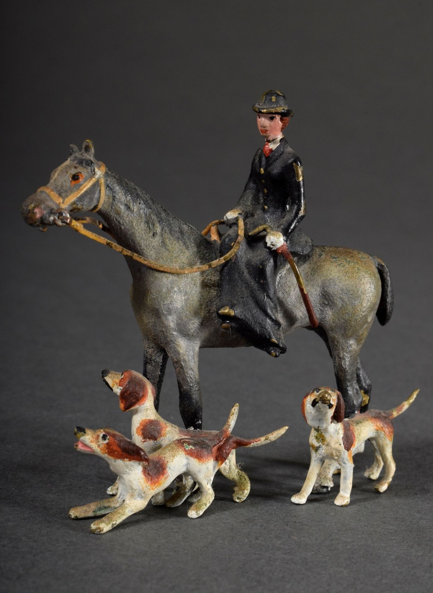 Viennese bronze "Hunt rider on horseback with three foxhounds", colourfully painted, h. 7cm, slight