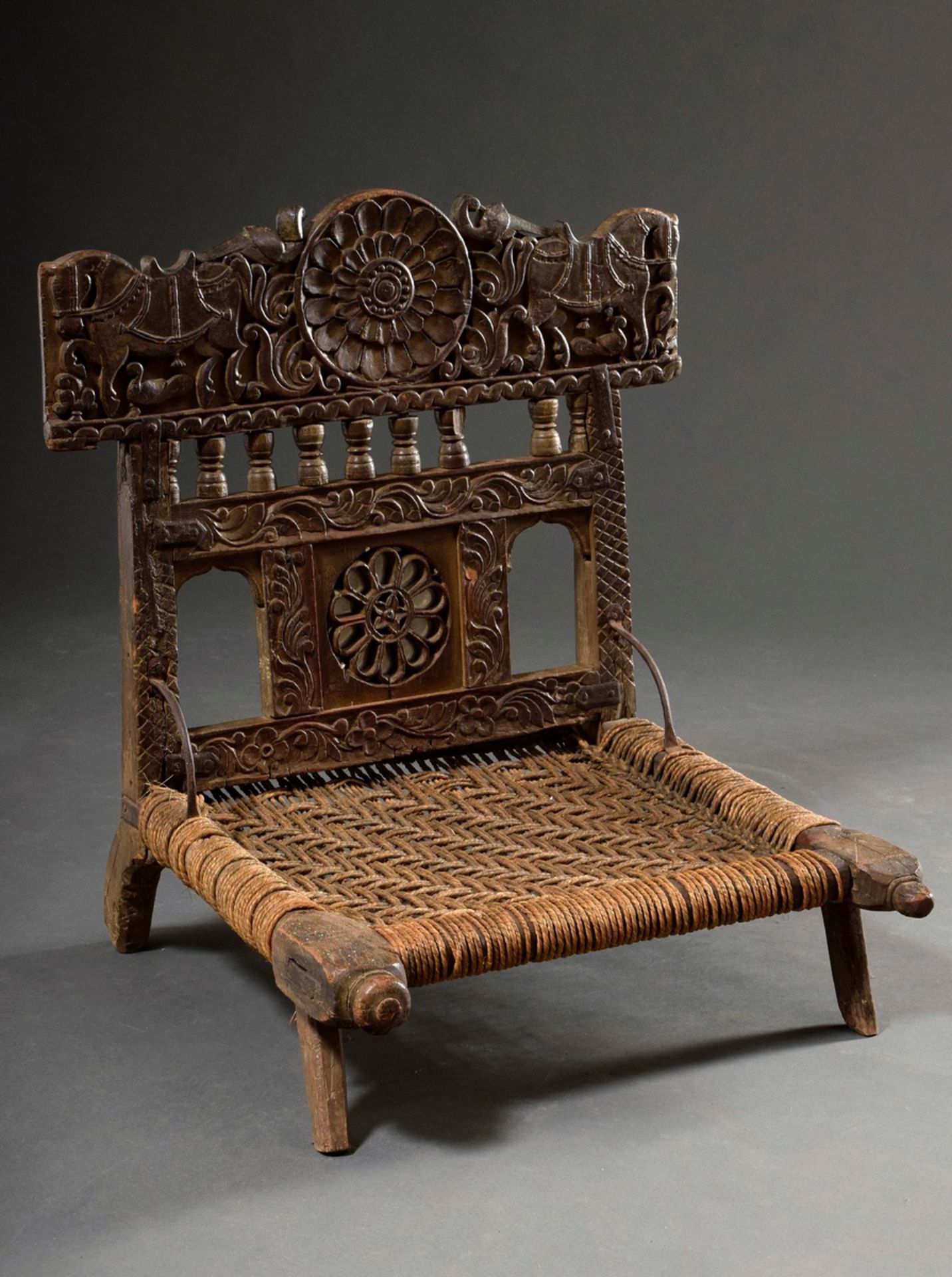 Indian wedding chair with richly carved frame "horses, peacocks and rosettes", around 1900, wood wi