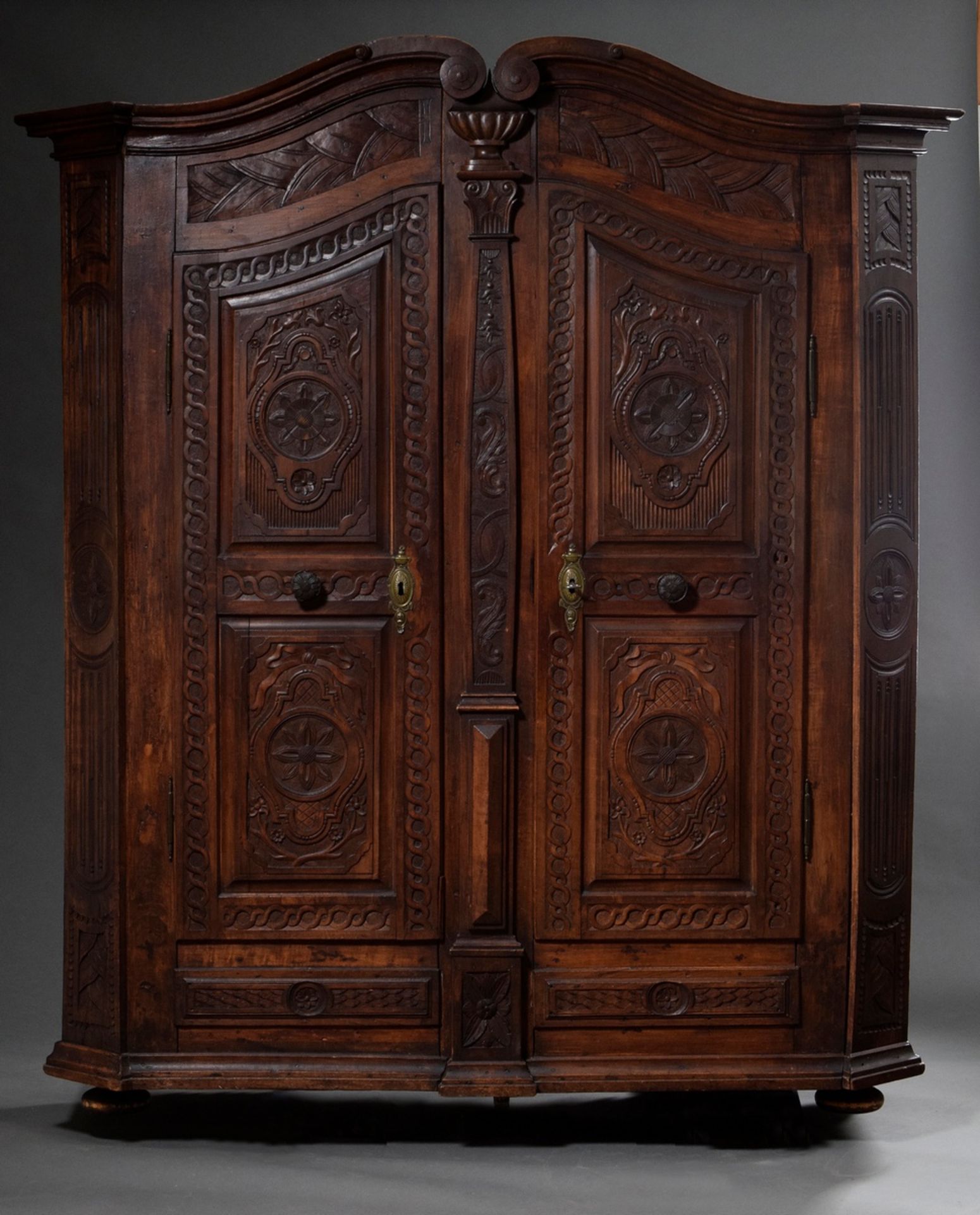 Alsatian peasant cabinet with richly carved corpus in Louis XVI style, softwood dark stained, aroun