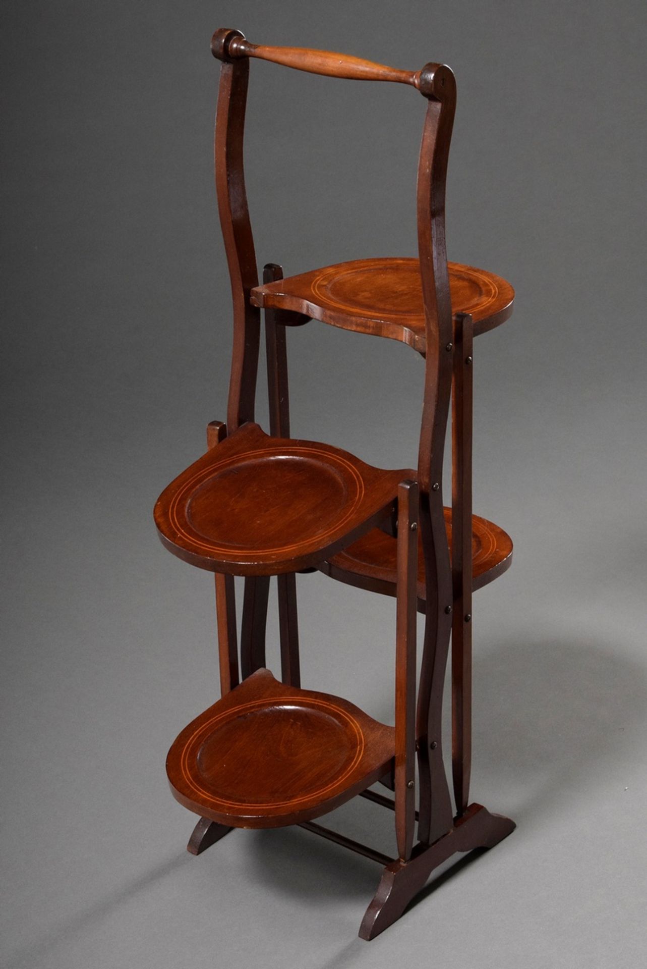 Mahogany cakestand with ribbon inlays, turned frame and two folding plate stands on each side, c. 1 - Image 2 of 4