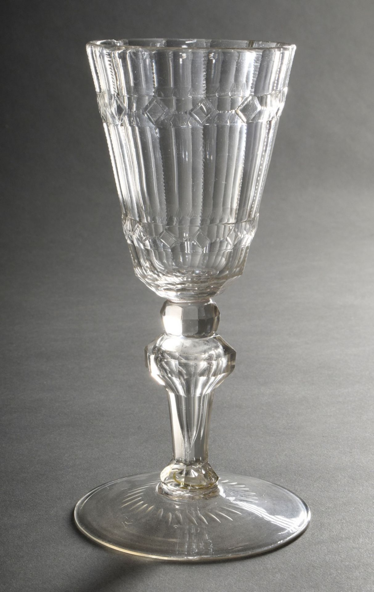 Baroque goblet glass on a broad plate base with baluster stem, pierced air bubble and rich facetted