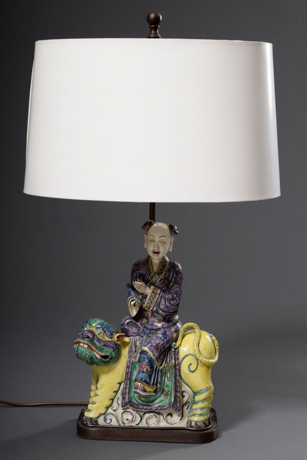 Table lamp with faience figure "Rider with scroll on fo lion" after Asian model, colourfully painte