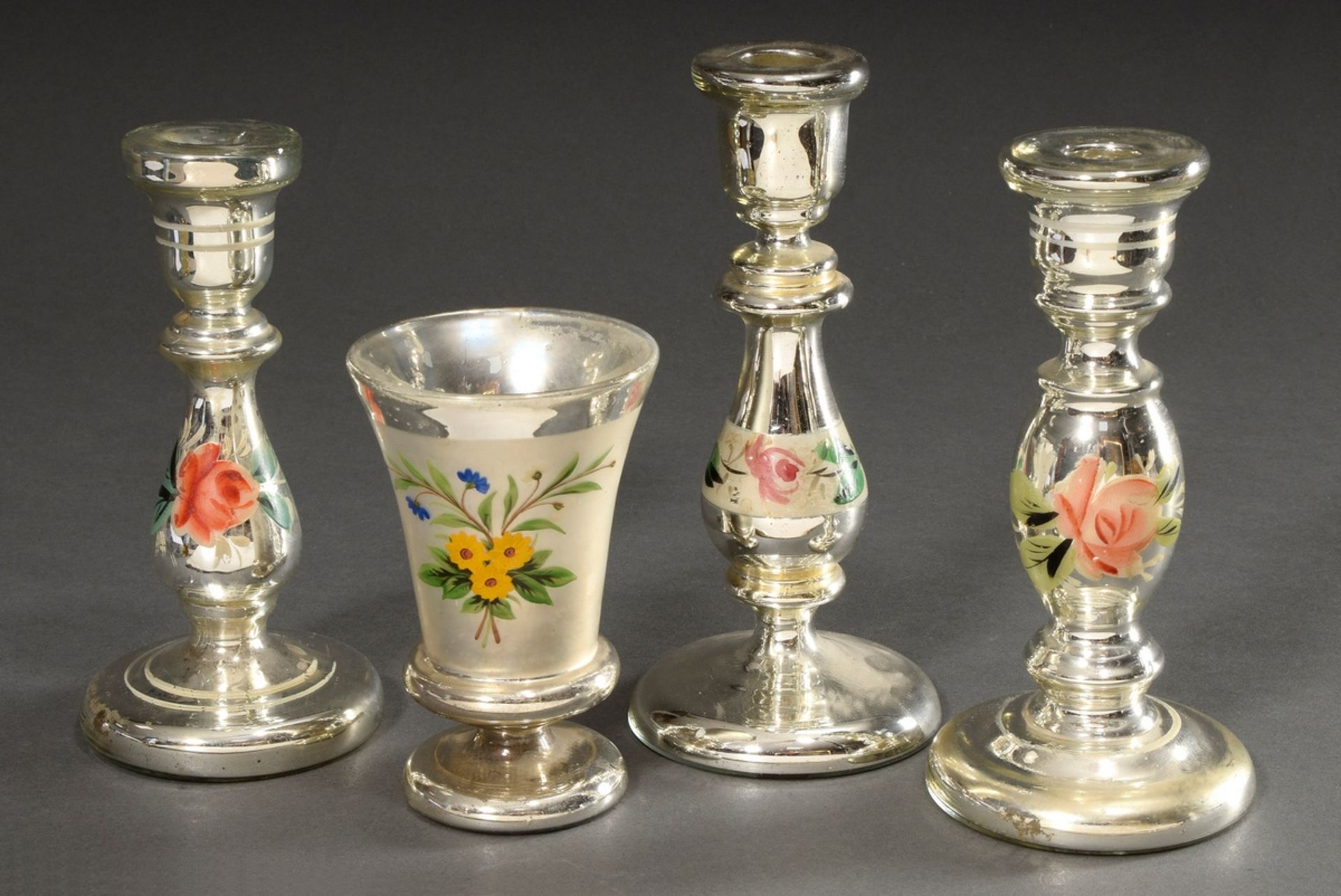 4 Various pieces of mercury silver: 1 goblet and 3 candlesticks with "flowers" decor, h. 14-22,5cm,