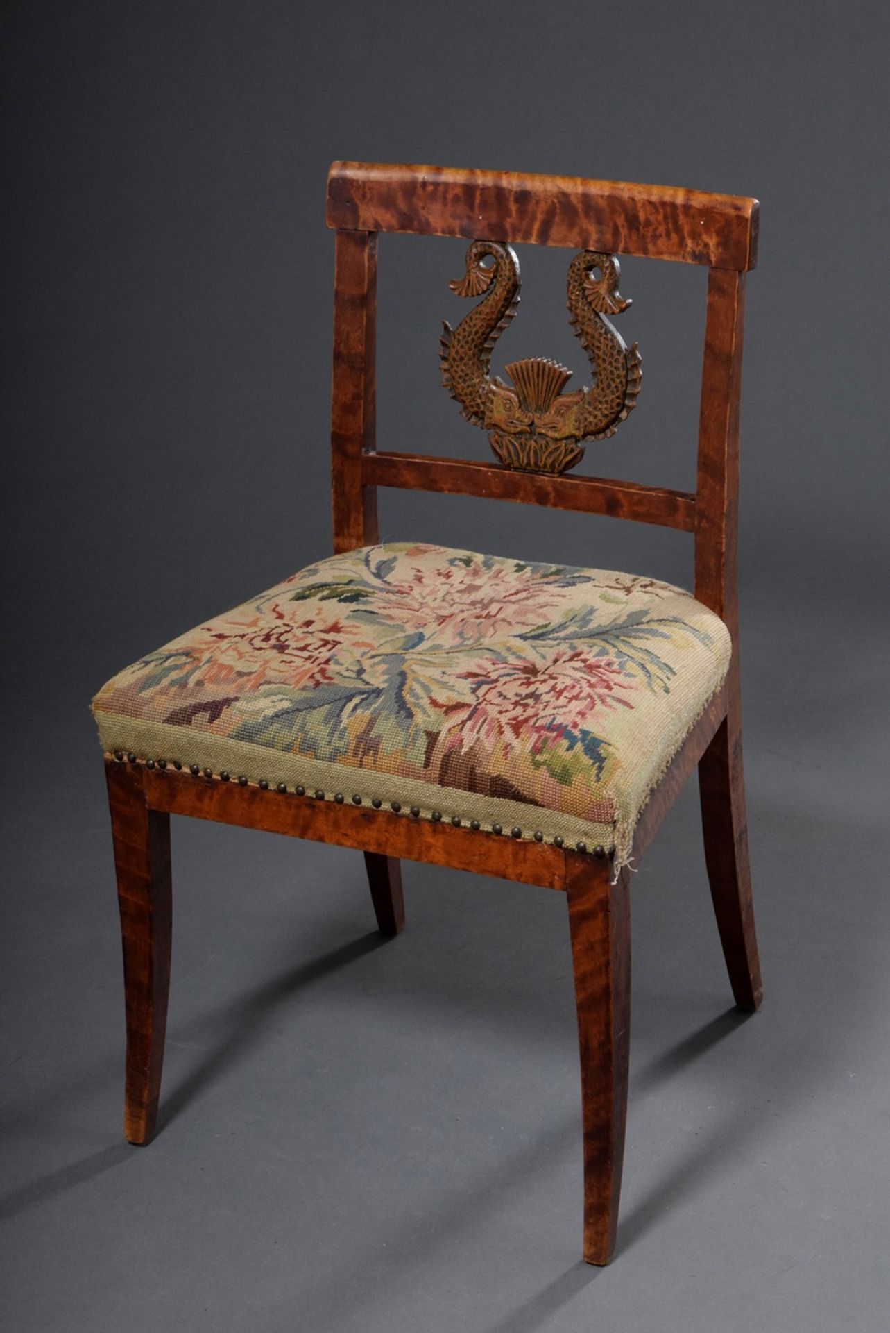 Empire chair in straight form with carving element "fish" in the backrest and embroidery upholstery