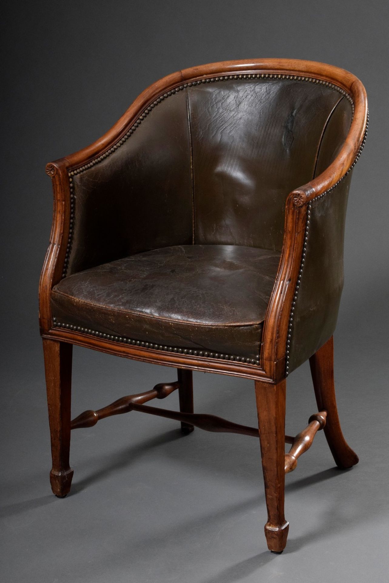 English "Tub Chair" with finely carved mahogany frame and original green leather upholstery, Englan