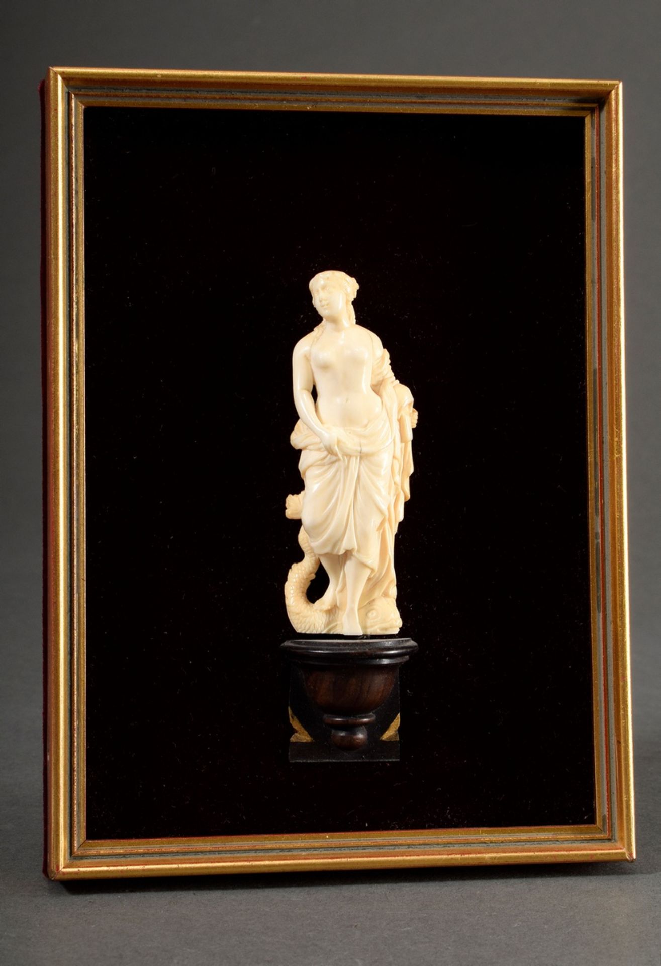 Small ivory carving "Amphitrite" mounted on a wooden console in framing with red velvet, 19th centu