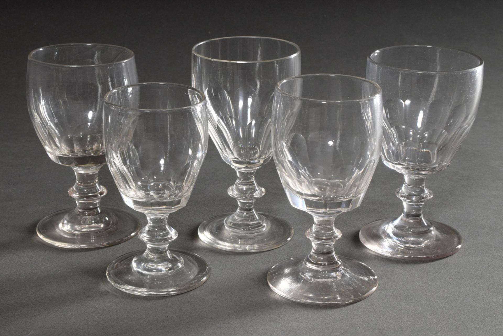 5 wine glasses with half surface cut and disc mode in the stem, colourless glass, varying in height