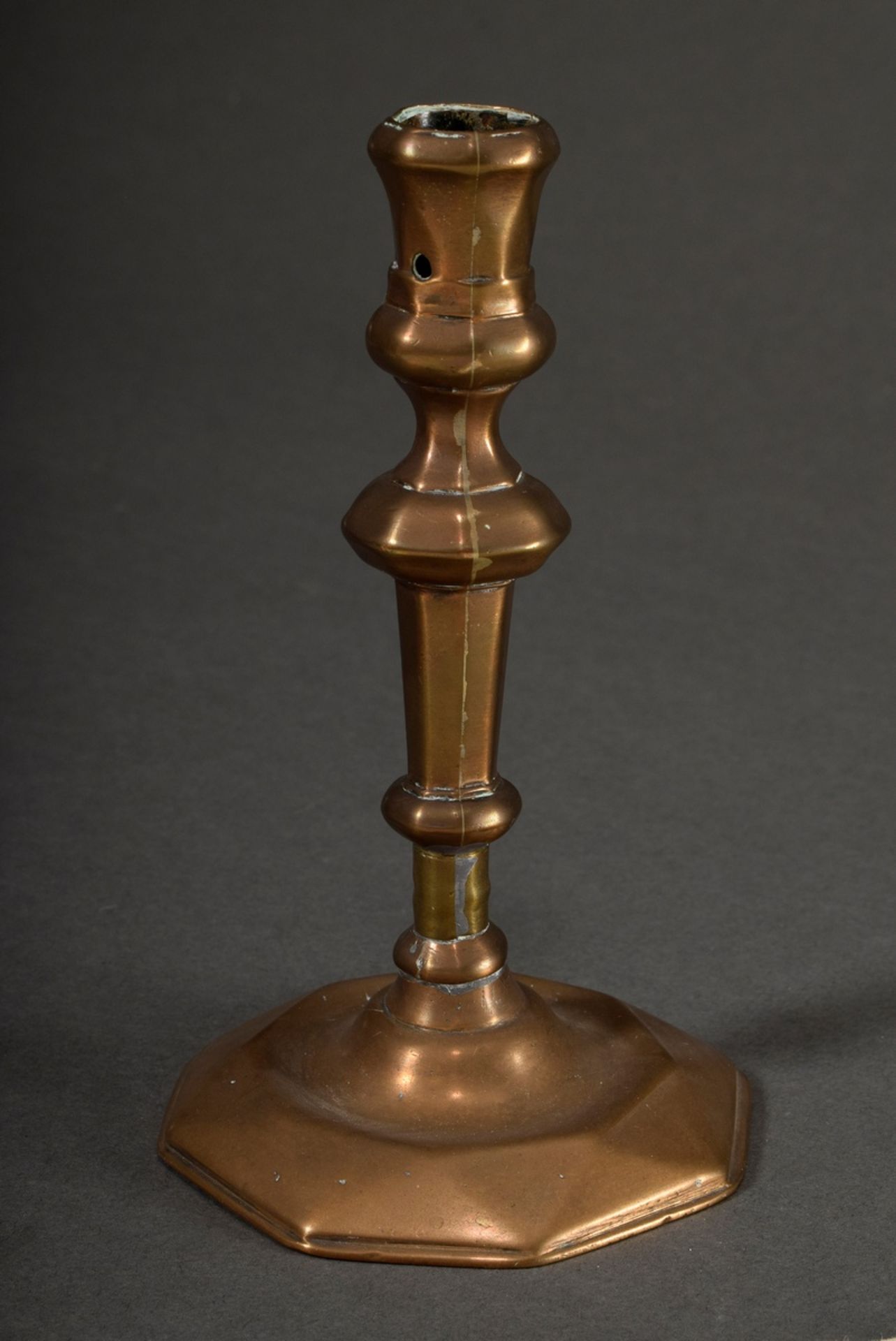 Faceted bronze candlestick with wax drip hole and baluster shaft on hexagonal base, 18th century, h