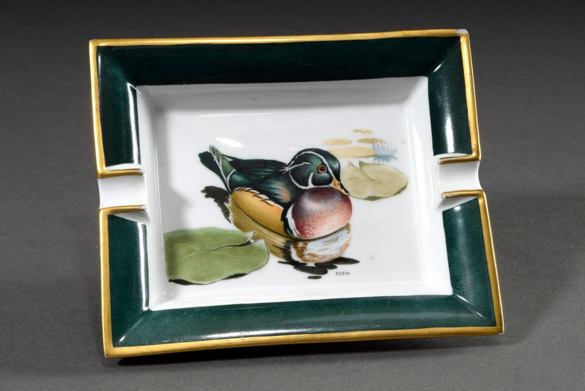 Hermès porcelain ashtray "Brautente", colourfully painted in green/gold, sign. Rybal, 19x18cm, rubb