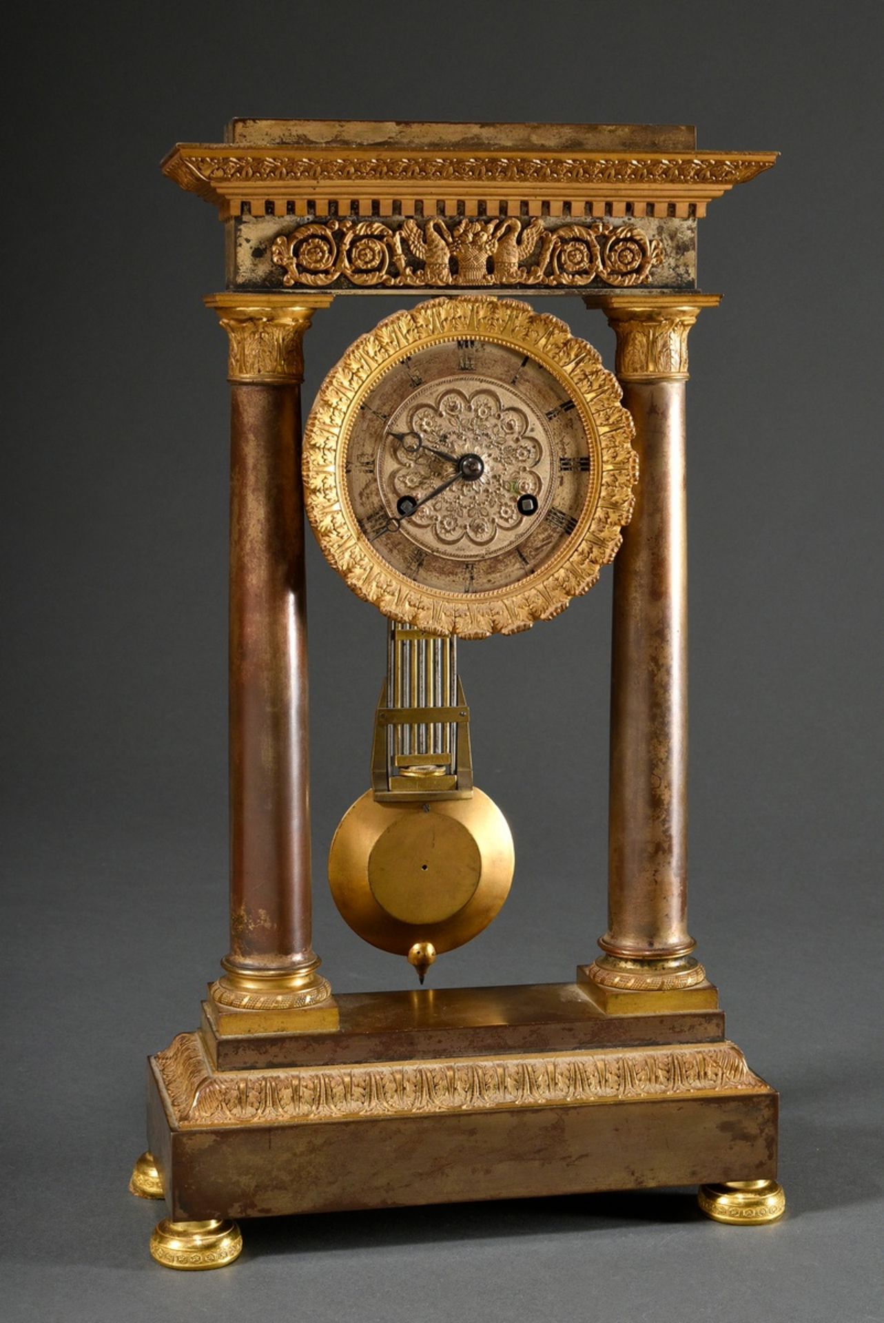 Biedermeier portal clock with patinated and fire-gilt case, floral relief dial with Roman numerals,