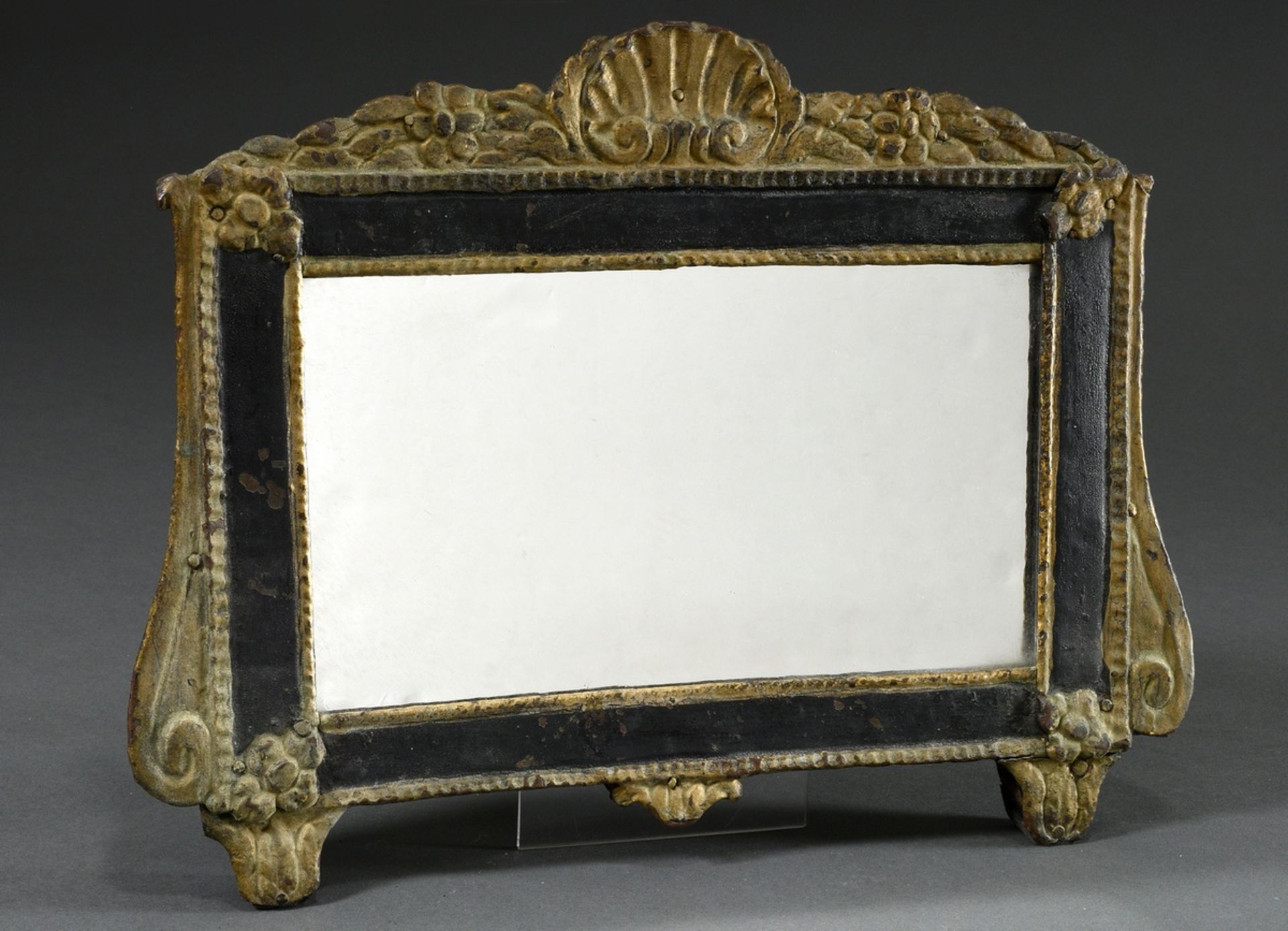 Small transverse mirror with rustic floral ornamentation and shell crowning, carved wood and black/