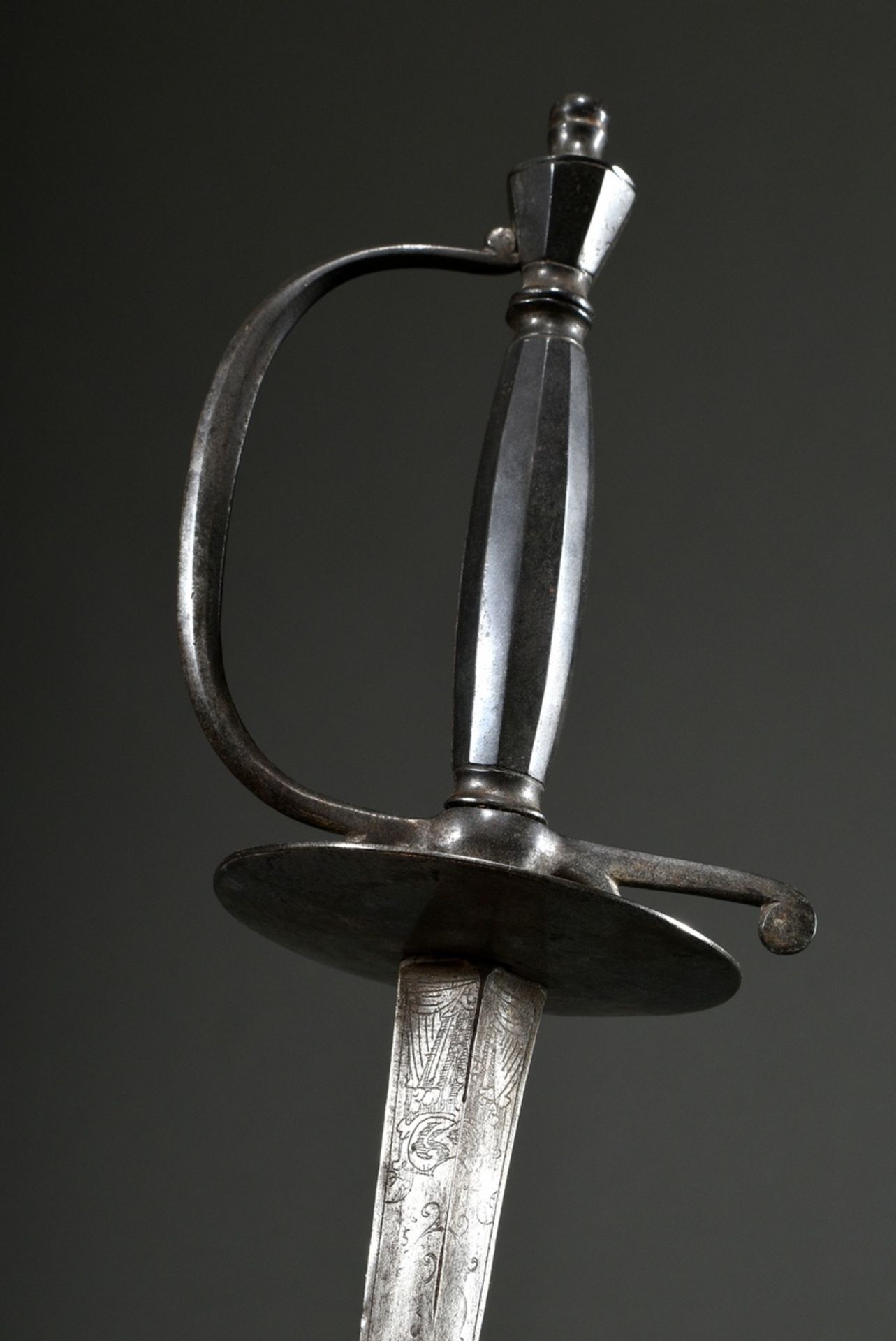 Ornamental court sword with triangular blade engraved with ornaments and iron hilt, consisting of: 