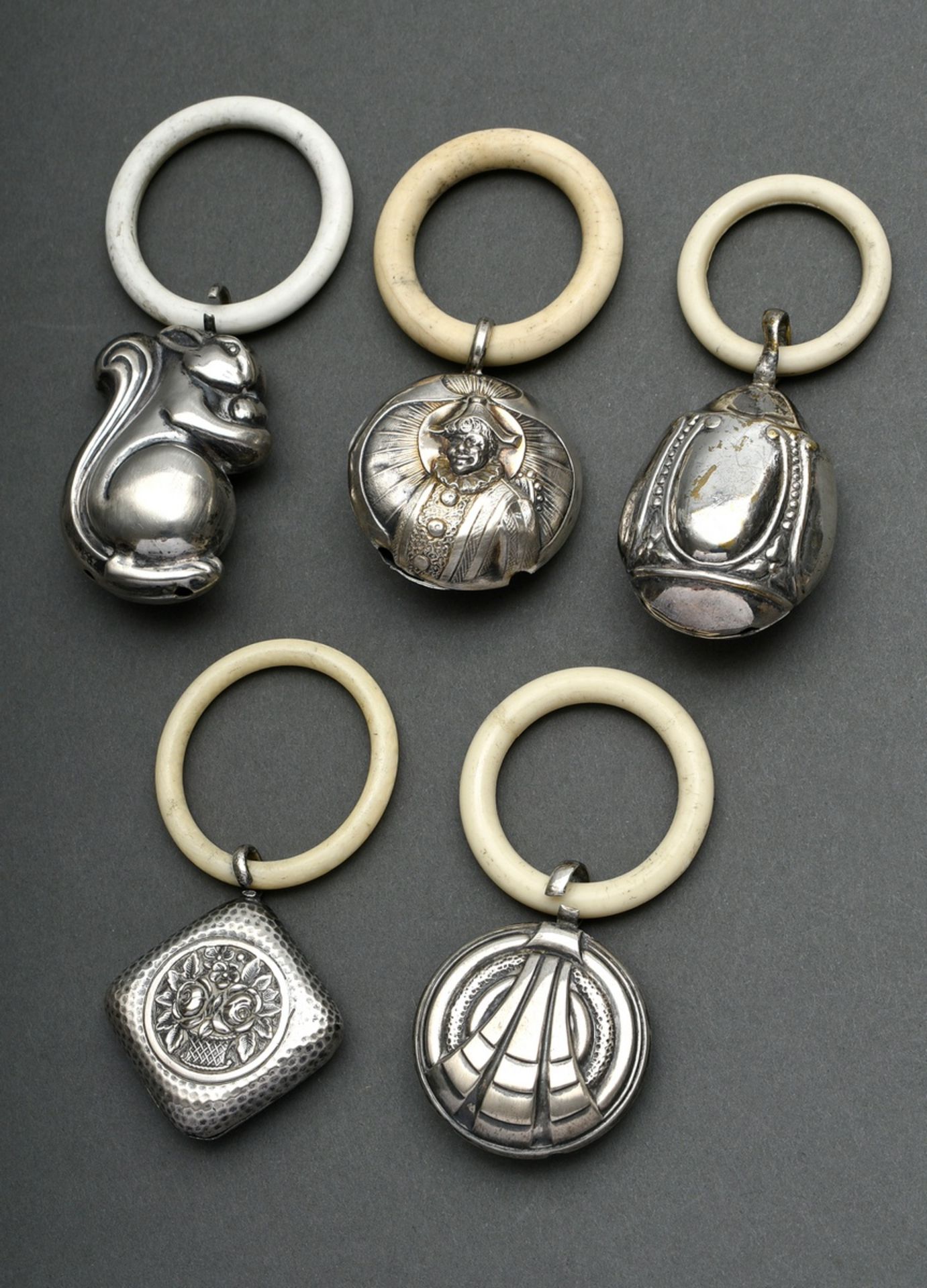 5 Various baby rattles with teething rings of white galalith, silver/silver-plated, early 20th cent