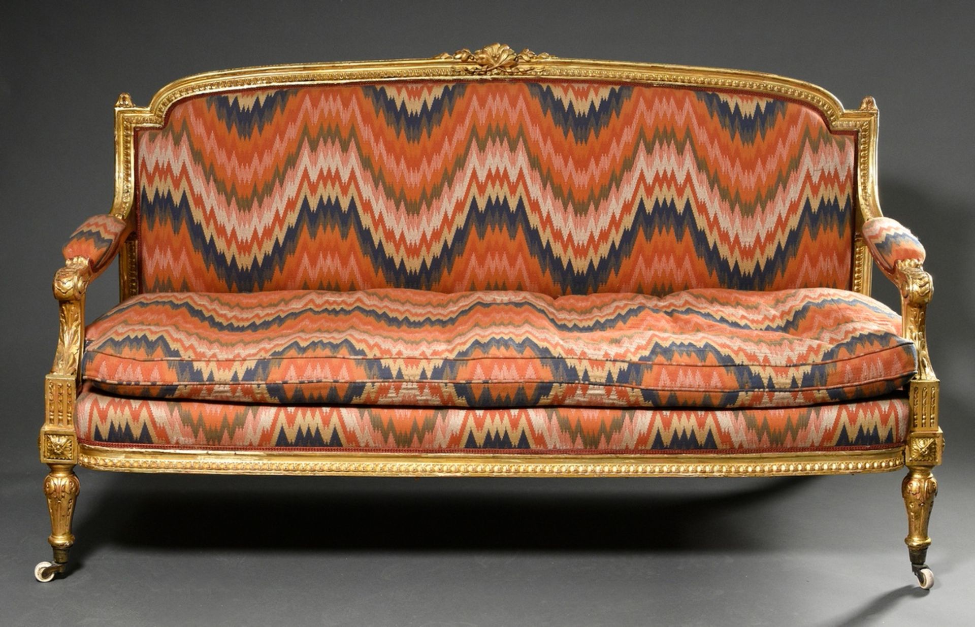 Louis XVI style sofa with leaf-gilded carved frame and opulent upholstery fabric in ikat look, arou