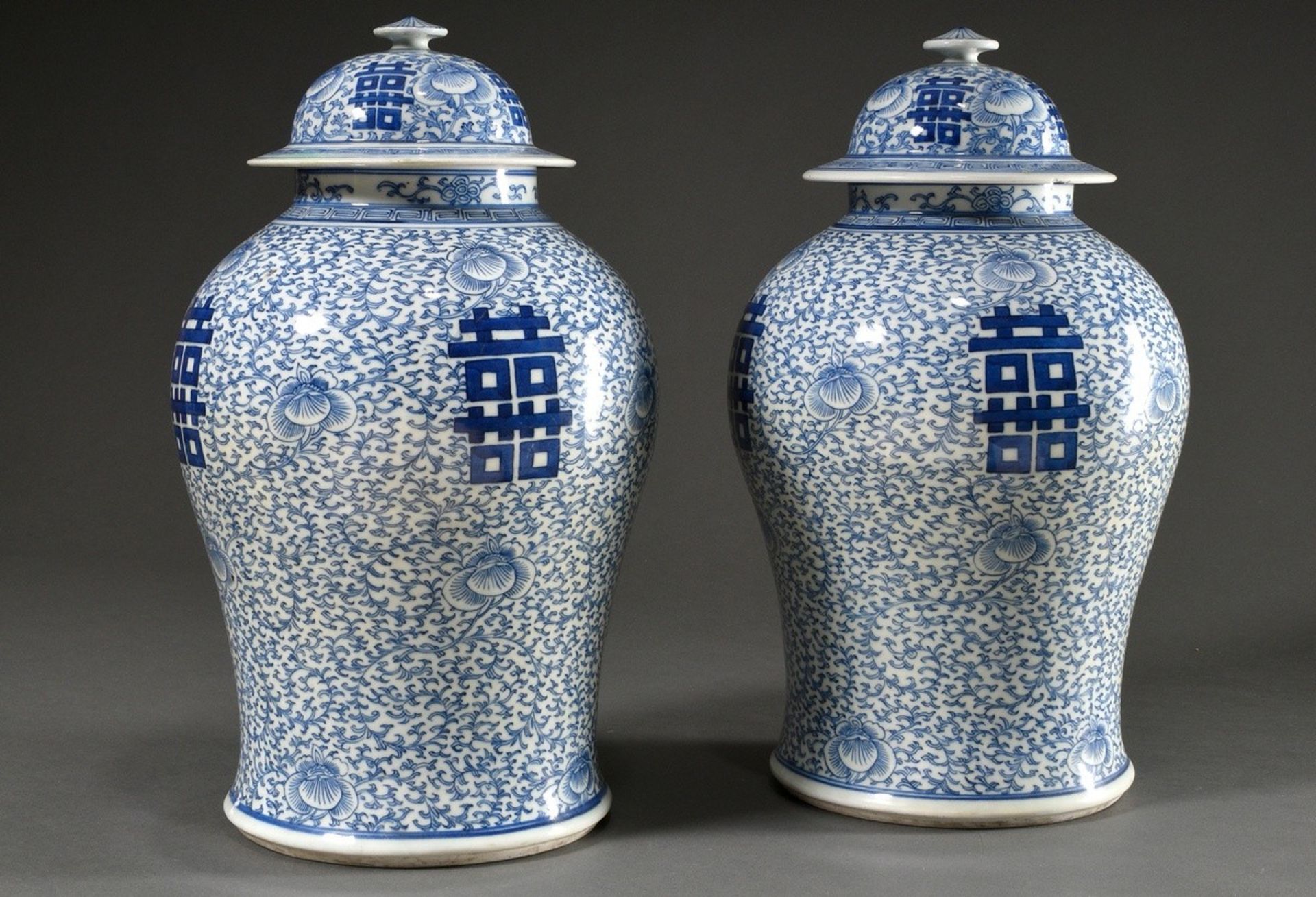 Pair of large Chinese porcelain lidded vases in baluster form with floral blue-and-white painting a