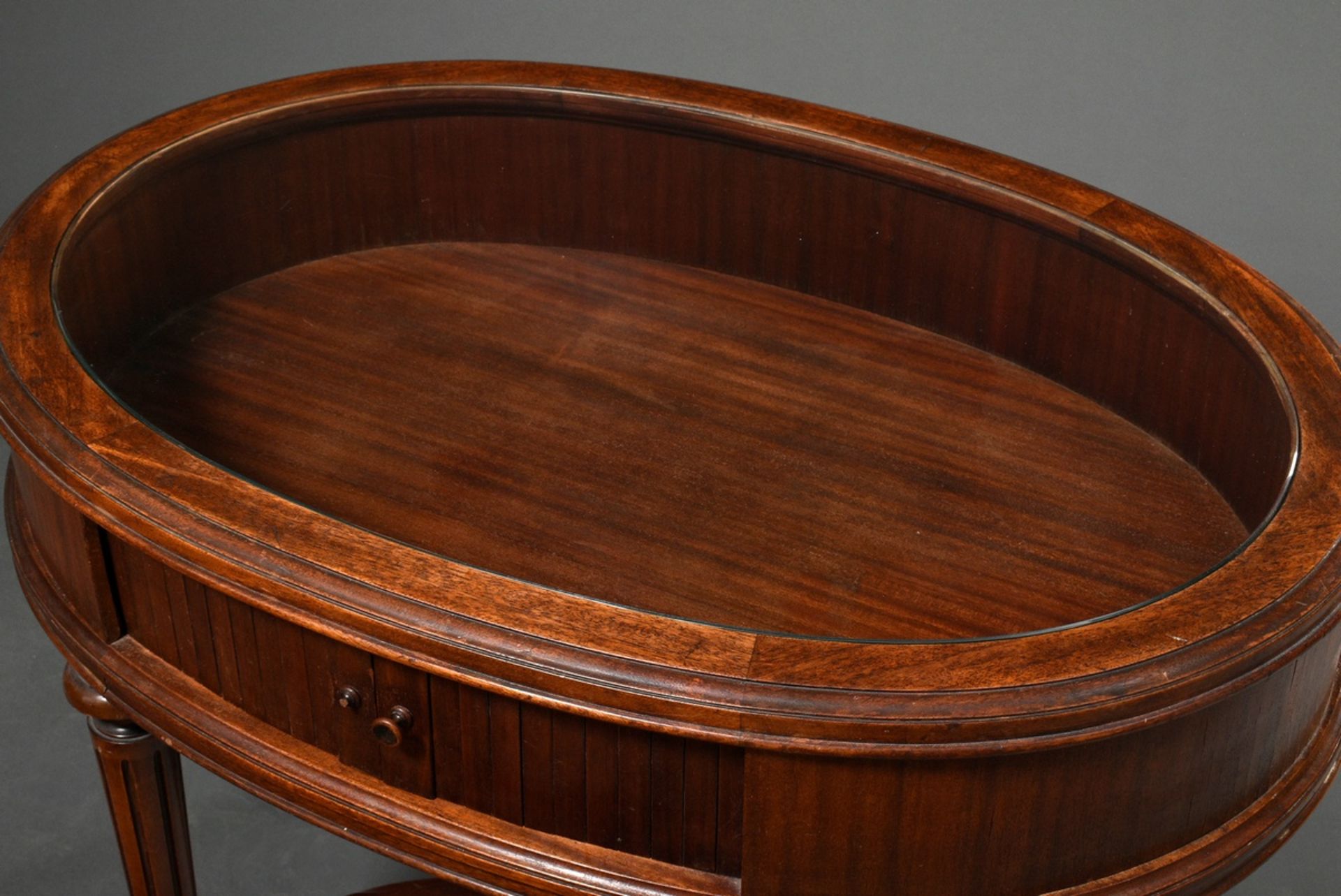 Low oval mahogany display table with glass top and side roll closure, underside signed. "Paul Tibur - Image 2 of 6
